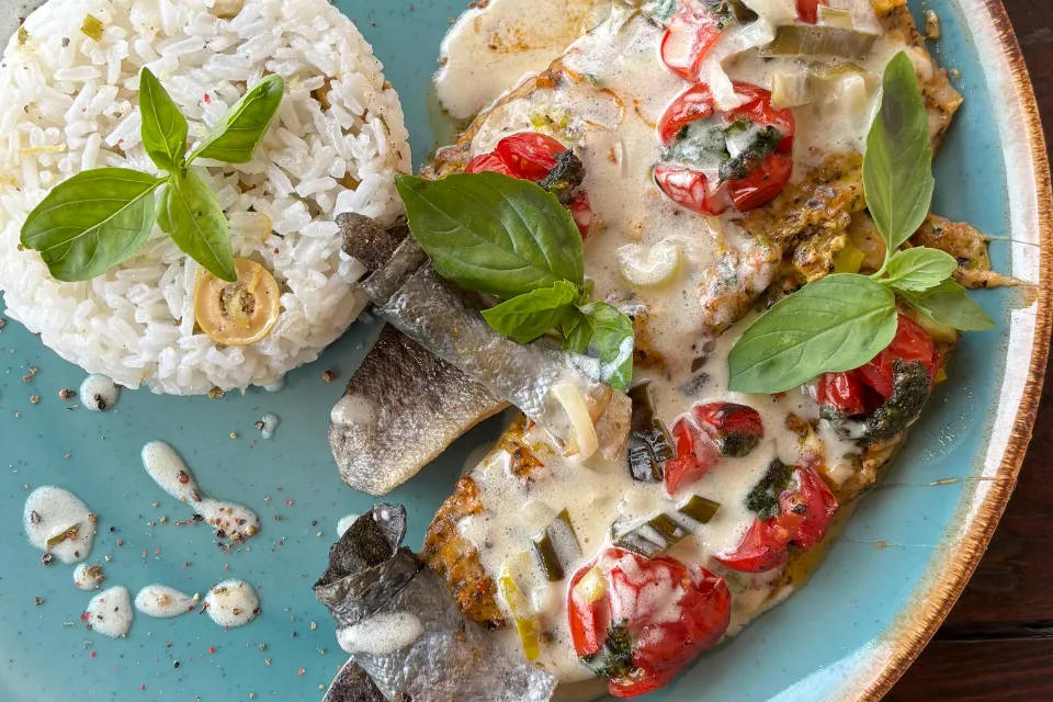 Skin-on roasted trout caprese, with citrus green olive jasmine rice and leek white wine sauce