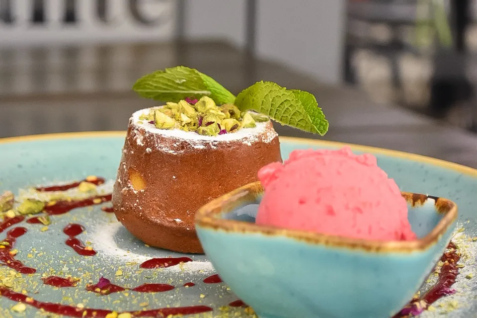 White chocolate pistachio soufflé, with raspberry ice cream